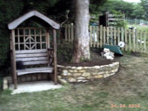 Garden seat by walled tree